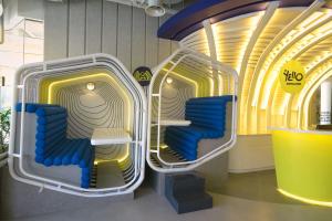 an empty room with blue seats in a machine at YELLO Hotel Kuta Beachwalk Bali in Kuta