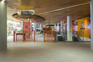 a shopping mall with a sign hanging from the ceiling at YELLO Hotel Kuta Beachwalk Bali in Kuta
