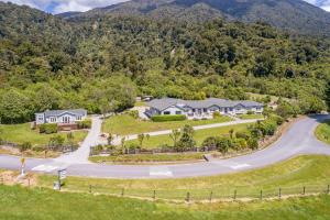 an aerial view of a home with a winding road at Lake Brunner Lodge in Moana