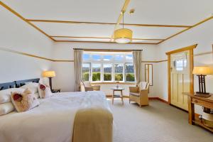 a large bedroom with a large bed and a desk at Lake Brunner Eco Lodge in Moana