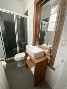 a bathroom with a sink and a toilet at Casa Urriola B&B in Valparaíso