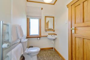a bathroom with a toilet and a sink at Lake Brunner Eco Lodge in Moana