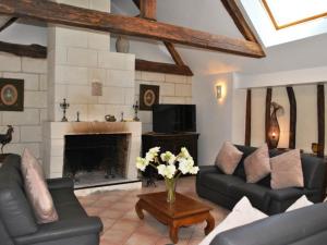 a living room with a couch and a fireplace at Gîte Azay-sur-Cher, 6 pièces, 11 personnes - FR-1-381-359 in Azay-sur-Cher