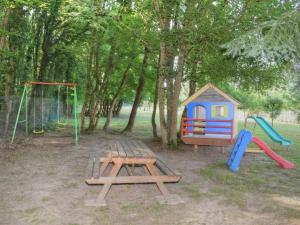 a playground with a picnic table and a play set at Gîte Azay-sur-Cher, 4 pièces, 5 personnes - FR-1-381-220 in Azay-sur-Cher