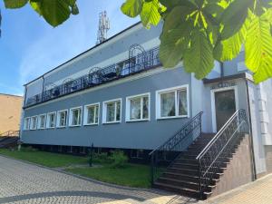 a building with stairs on the side of it at Pensjonat Sielec in Sosnowiec