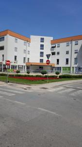 an empty street with two yield signs in front of a building at Apartman VIP, with Free Garage Parking in Pula