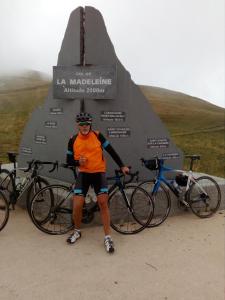 a man standing next to two bikes in front of a monument at juste pour le plaisir in Saint-Pierre-dʼAlbigny