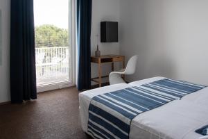 Postel nebo postele na pokoji v ubytování Albergo alla Spiaggia