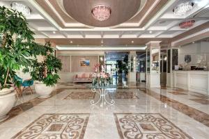 a lobby with a table and plants in it at Siena Palace - Free parking in Primorsko