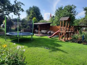 a yard with a trampoline and a playground at Apartman U Adamov in Liptovský Mikuláš