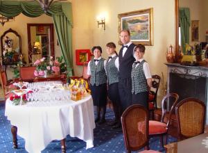 a group of people standing in front of a table at Hotel Vittoria in Premeno