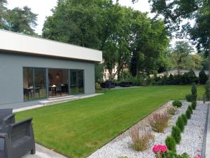 a garden with a lawn and a house at Apartamenty Willa Atena in Świnoujście