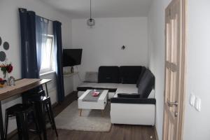 a living room with a couch and a table at Apartman ANA Livno - biker friendly in Livno