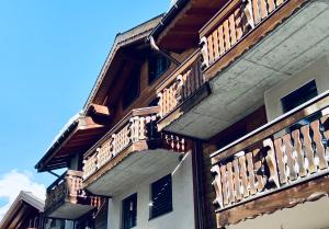 a building with wooden balconies on the side of it at Saas-Fee renovated flat in center of the village in Saas-Fee