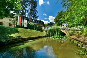 a river with a bridge in a city at Park Hotel Kaylaka in Pleven