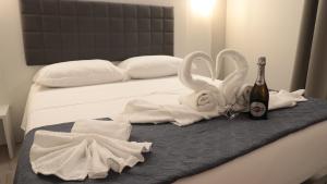 a bed with white towels and a bottle of champagne at Blue Marine in Tropea