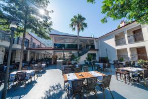 an outdoor patio with tables and chairs in a courtyard at Sundia By Liberty Oludeniz in Oludeniz
