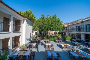 an outdoor patio with tables and chairs in a courtyard at Sundia By Liberty Oludeniz in Oludeniz