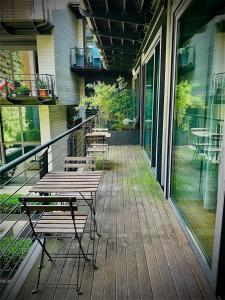 a porch with benches and tables on a house at Green 152 - Luxury Apartments Rome Colosseum Monti in Rome