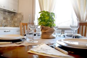 a table with plates and glasses and a plant on it at LìRìcordi in Isola del Liri +34 photos