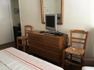 a bedroom with a dresser with a television on it at AGIA PARASKEVI appartement près du métro in Athens