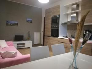 奧利韋里的住宿－Tindari guest house，客厅配有白色桌子和粉红色沙发