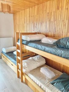 a bunk bed with three bunk beds in a room at Chamrousse Gentian Cap 2000 Parking #F1 in Chamrousse