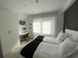 Posteľ alebo postele v izbe v ubytovaní Hostal Somnis