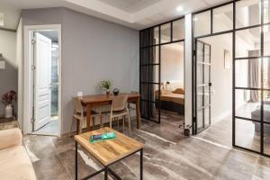 a living room with a table and a bedroom at Veli group Apartment in Old City in Kutaisi