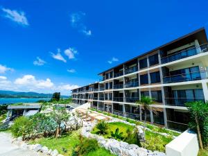 an apartment building with a view of the water at Away Okinawa Kouri Island Resort in Nakijin