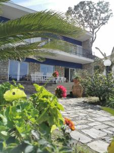 a house with a stone patio in front of it at Villa Maria Luxury Suites in Sperlonga