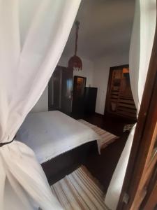 a bedroom with a bed with a curtain at ANASTASIA STONE HOUSE in Psakoudia