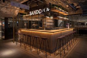 a bar in a restaurant with bar stools at Kyoto Tower Hotel in Kyoto