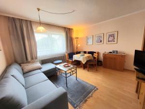 a living room with a couch and a table at Haus Mirabell in Bad Füssing