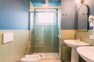 a bathroom with a shower and a toilet and a sink at Sorrento Colors&Suites in Sorrento