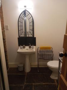 a bathroom with a sink and a toilet at Delighful self catering in the heart of Glastonbury in Glastonbury