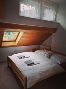 a bedroom with a white bed with a window at BOUDA MORAVA in Dolni Dvur