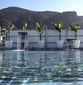 a pool with potted plants on top of a building at Glaros Royal Beach Hotel in Hersonissos