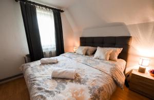a bedroom with a large bed with two pillows on it at Villa Vucipolje in Posušje +34 photos