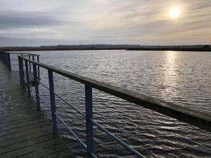 a dock with a view of a body of water at Ferielejlighed ved Vilsted Sø in Løgstør