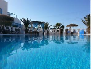 a swimming pool with blue water in a resort at Villa Livadaros in Karterados