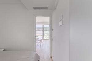 a bedroom with a bed and a view of a table at Capo Falcone Charming Apartments in Stintino