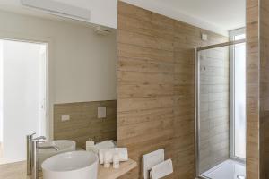 a bathroom with a sink and a shower at Capo Falcone Charming Apartments in Stintino