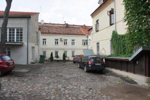 a group of cars parked in a parking lot next to buildings at Heart of Vilnius Apartment in Vilnius