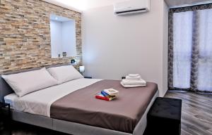 a bedroom with a large bed and a brick wall at Terra Mia Savoia B&B in Naples