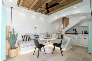 a living room with a white couch and a table at Majo Suites Hotel in Agia Anna Naxos