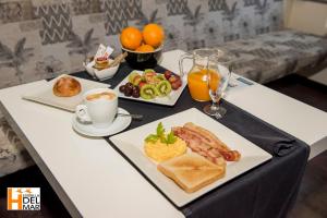 a table with two plates of breakfast foods and orange juice at Hotel Boutique Estrella del Mar - Frente al mar, con desayuno, en el centro de Peñíscola in Peniscola