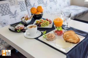 a table with a tray of breakfast food on it at Hotel Boutique Estrella del Mar - Frente al mar, con desayuno, en el centro de Peñíscola in Peniscola