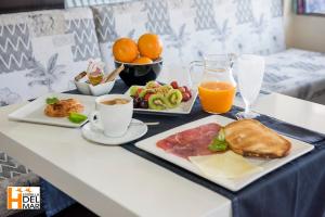 a breakfast table with two plates of food and orange juice at Hotel Boutique Estrella del Mar - Frente al mar, con desayuno, en el centro de Peñíscola in Peniscola