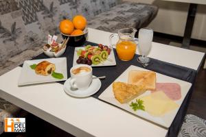 a table with breakfast foods and drinks on it at Hotel Boutique Estrella del Mar - Frente al mar, con desayuno, en el centro de Peñíscola in Peniscola +38 photos